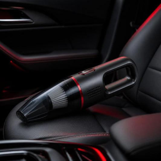 Compact cordless car vacuum on a dark leather car seat